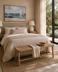 Mediterranean bedroom with natural wood bedside tables, woven bench, soft linen textiles and coastal artwork in a calm Mallorca- Mediterranean bedroom with natural wood bedside tables, woven bench, soft linen textiles and coastal artwork in a calm Mallorca-
