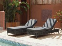 Modern outdoor sun loungers by the pool on Mediterranean terrace in Mallorca