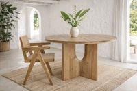 ash wood dining table with cane chair in ibiza style mediterranean interior mallorca with natural light and jute rug
