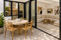 Seamless indoor-outdoor living with terrace dining area opening into a contemporary living room in Santa Catalina, Palma.