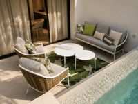 Pool terrace in a Santa Catalina townhouse in Palma with contemporary outdoor lounge furniture, soft Mediterranean textiles, private plunge pool and relaxed indoor-outdoor living.