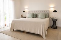 Extra large Swedish pocket spring Super King bed in a Santa Catalina townhouse in Palma with soft neutral textiles, natural Mediterranean light and elegant contemporary bedroom styling.