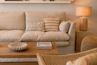 Warm Mediterranean living room with linen sofa, wooden coffee table and natural textures in calm contemporary style.